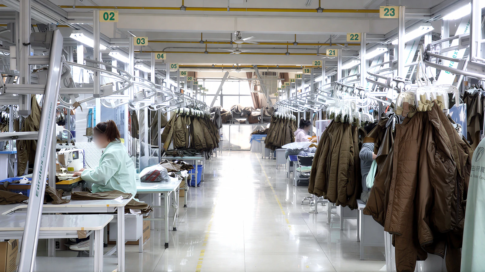 Smart hanging rails and garments along a bright production aisle